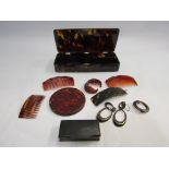 A tortoiseshell box with combs, earrings, a small tortoiseshell backed circler mirror,