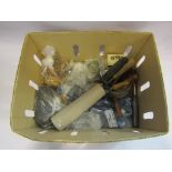 A box containing a selection of items including mantel clock, vintage hair curlers, shoe stretchers,