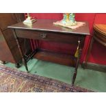 An Arts & Crafts walnut rising top with drop down frieze writing table having a fitted interior and