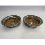 A pair of silver plate wine coasters,