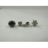 A diamond set drop earring and a sapphire and diamond cluster earring with a paste set daisy stud,