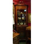 In the manner of "Maple & Co" an Edwardian inlaid mahogany full height corner cabinet,