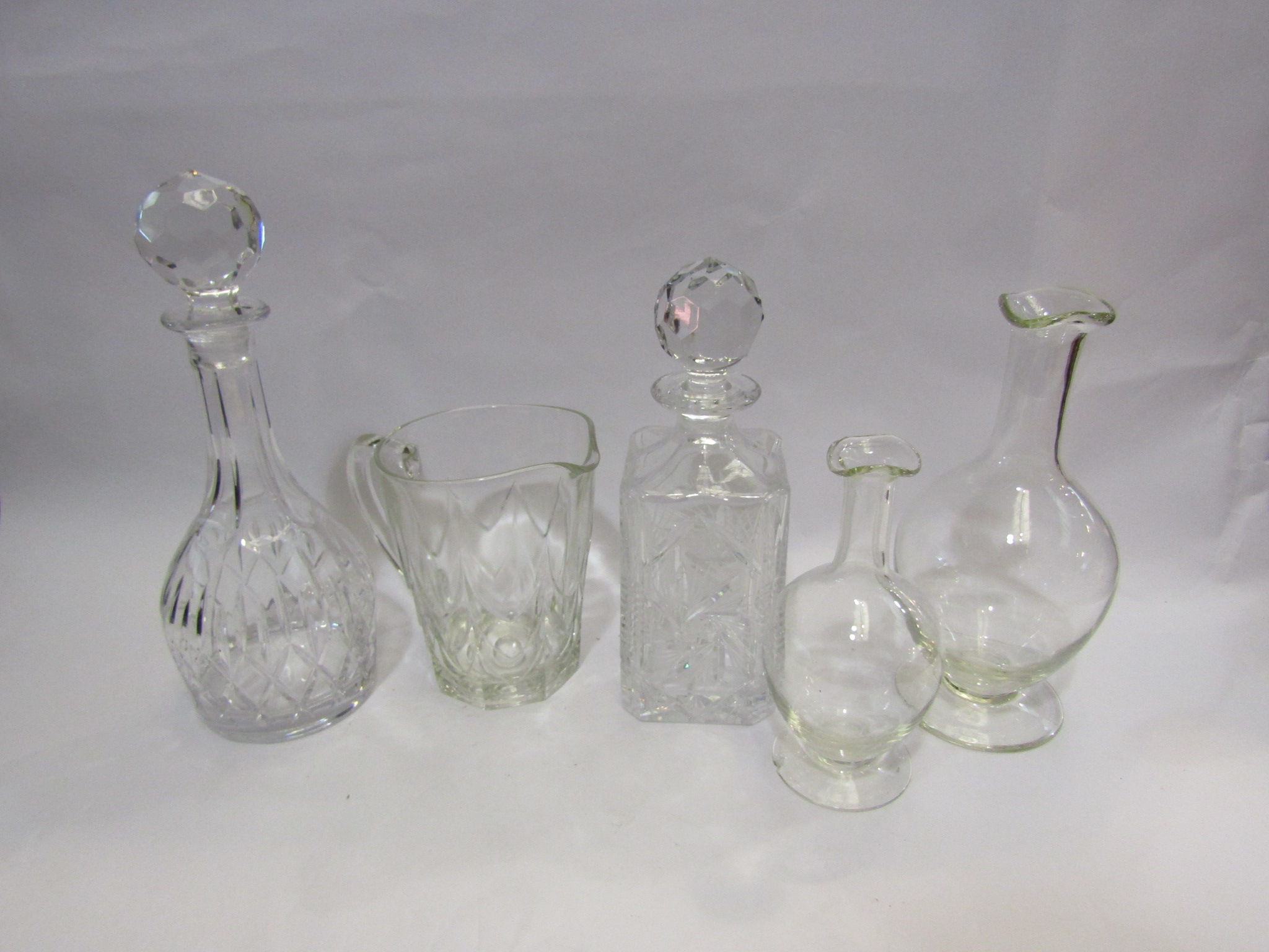 A selection of cut glass decanters, carafes,