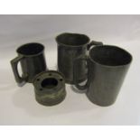 Three pewter tankards one depicting a stylised dragon and an inkwell,