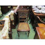 A pair of Circa 1900 oak bergère chairs with phoenix design back supports
