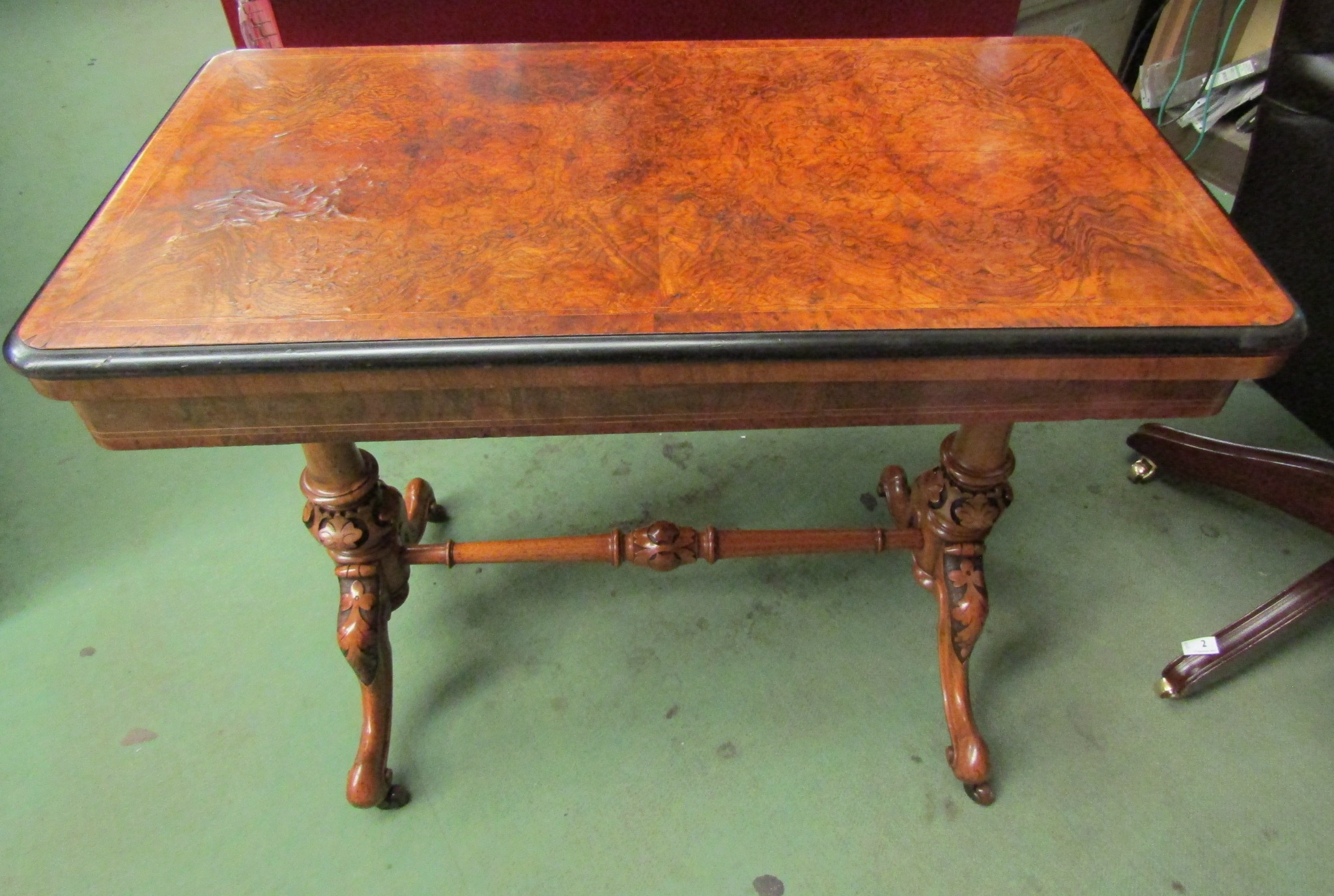 Stamped "Maple & Co" a burr walnut circa 1860 card table on turned and carved base with ceramic