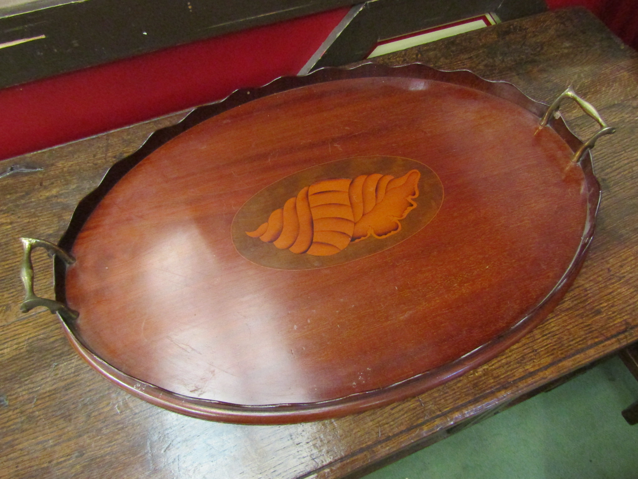 An Edwardian mahogany oval twin handled galleried tray with shell inlay