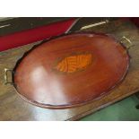 An Edwardian mahogany oval twin handled galleried tray with shell inlay