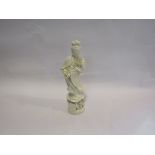 A Chinese blanc-de-chine figure of Guanyin, standing on floral encrusted plinth, 28.