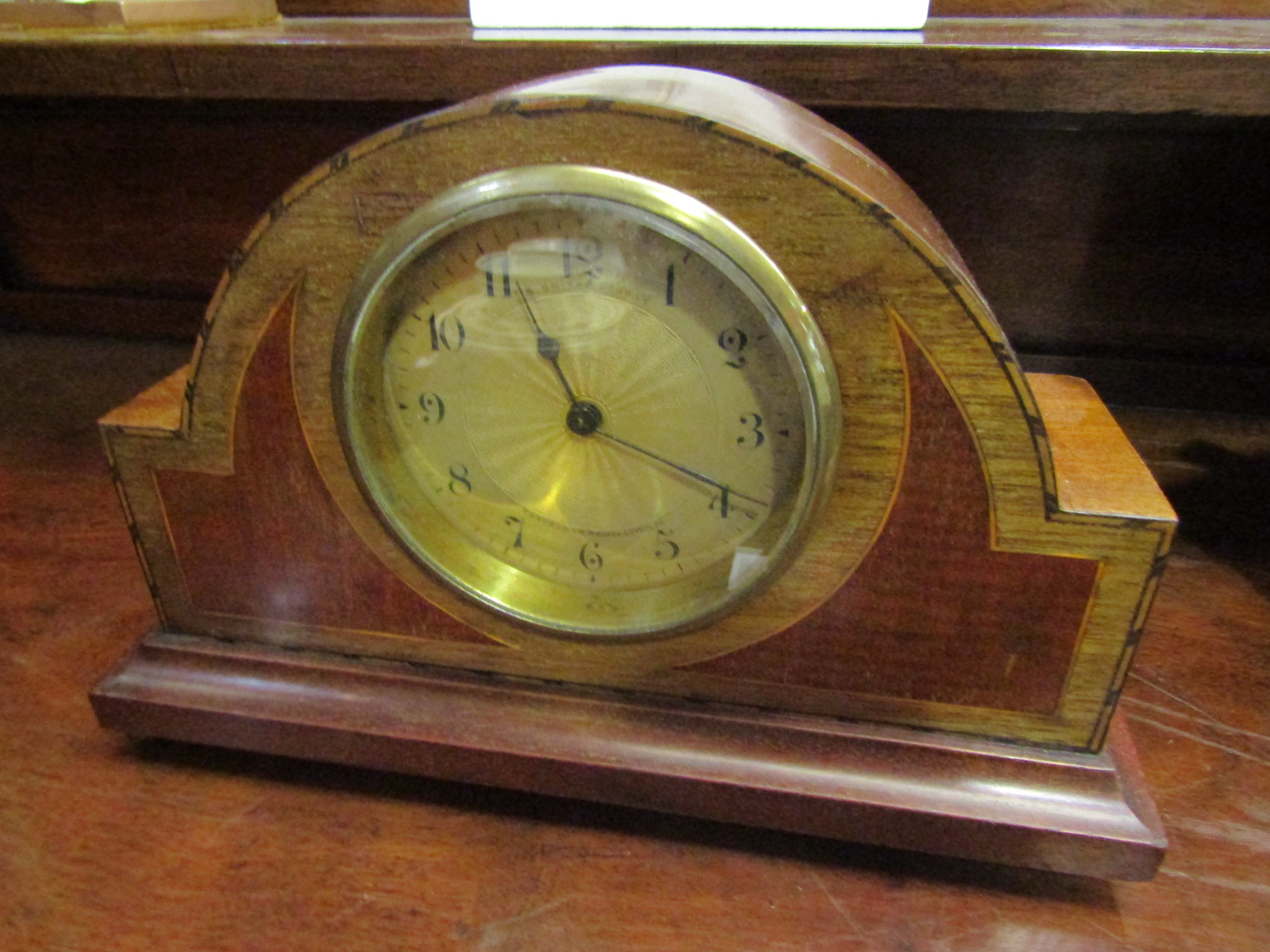 A mahogany inlaid mantel clock