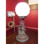 An Art Deco 1930's frosted glass lamp in the form of a kneeling lady with globular glass shade,