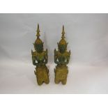 A pair of verdigris and gilt Eastern deities