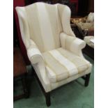 A Chippendale style George III revival wingback armchair the scroll arms and feather filled cushion