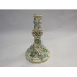 A Meissen porcelain candlestick decorated with flowers and insects, cross swords mark to base,