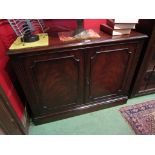 A Georgian style flame mahogany two door cupboard with key on a plinth base.