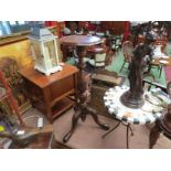 A Georgian style walnut jardiniere stand the carved and fluted column on a tripod base,