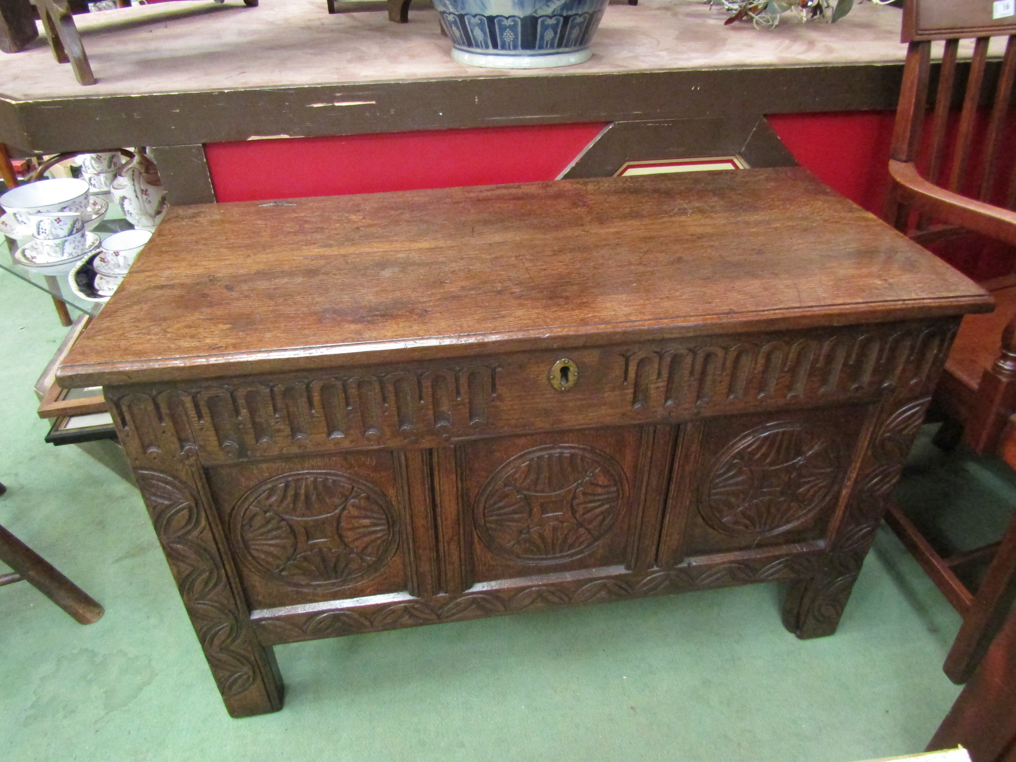 An 18th Century oak three panel coffer the hinged lid over stile feet.