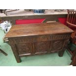 An 18th Century oak three panel coffer the hinged lid over stile feet.