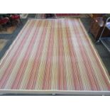 A "Paul Smith" style large wool rug with webbed edging and multi coloured striped pattern,