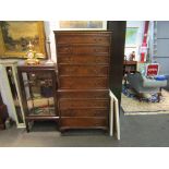 A 20th Century walnut tallboy/chest on chest of nine drawers,