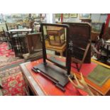 A Regency mahogany dressing table mirror with round cornered top held by two turned supports,