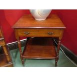 Stamped "Heal & Son, London" a late Victorian walnut two tier lamp table ,