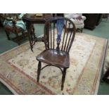 Circa 1800 a yew and elm Windsor chair with pierced central splat over ring turned legs joined by a