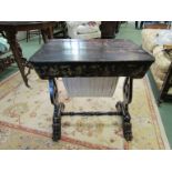 A Victorian chinoisserie lacquered work table on lyre end supports and hairy paw feet joined by a
