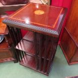 A Georgian style crossbanded inlaid mahogany revolving bookshelf on castors,