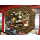 A brass mounted wooden wall mirror, embossed with shell rococo style motifs, bevelled edge,