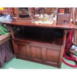 An 18th Century revival oak monk's bench the drop down table top over a hinged seat box seat settle