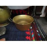 A Victorian two handled brass jam pan,