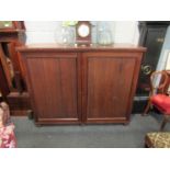 A George III mahogany gentleman's wardrobe, the twin panel doors opening to reveal tray space,