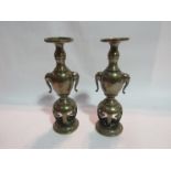 A pair of 19th Century Chinese polished bronze candlesticks with silvered inlay,