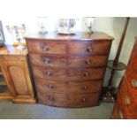 An early Victorian flame mahogany bow front chest of two short over four long graduating drawers