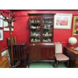 A George V mahogany bookcase on base,