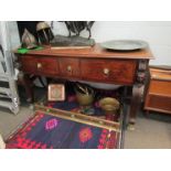 An 18th Century mahogany serving table with lion mask detail, three drawers with crossbanded detail,