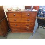 A Victorian mahogany round-cornered chest of two short over three long drawers, bun handles,