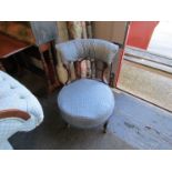 A Victorian walnut bedroom chair with blue upholstery on ceramic castors