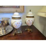 A pair of 19th Century ceramic and ormolu, lidded potpourri urns,