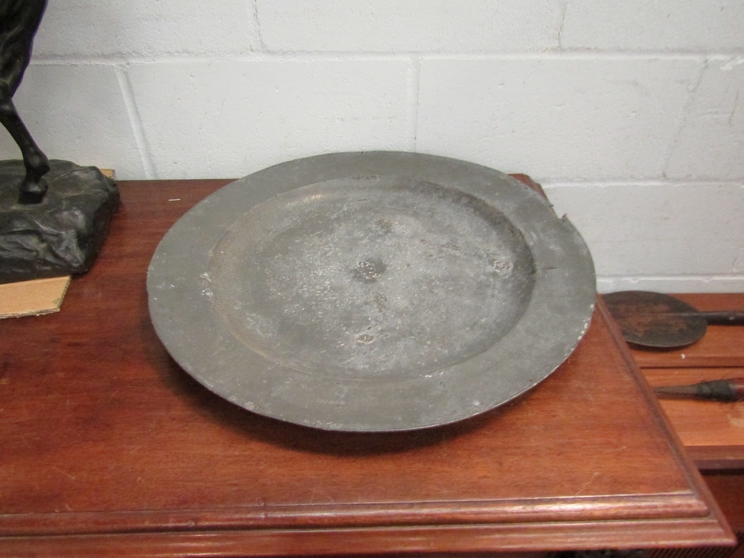 A large 18th Century pewter charger stamped Bowood,