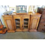 Circa 1840 a figured walnut breakfront bookcase the two glazed central doors with height adjustable