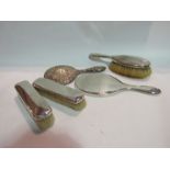 A silver backed four piece dressing table set and a silver backed hand mirror a/f