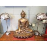 An Oriental brass figure of a Buddha, head repaired,