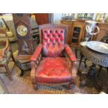 A pair of Victorian red leather button library armchairs