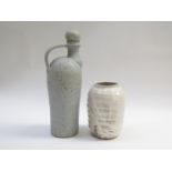 A studio pottery stoneware flask with handle and stopper with ash glaze and iron oxide spotting,