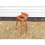 A Danish teak bar stool designed by Erik Buck.