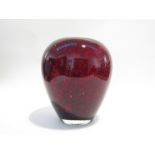 A Murano art glass oviform vase in red with mottled black pitting. 25.