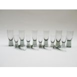 A set of nine Holmegaard "Canada" grey range shot glasses, 8cm tall, plus a set of six 11.