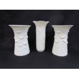 A pair of Kaiser porcelain white matte vases with relief moulded flowers and butterflies, No.